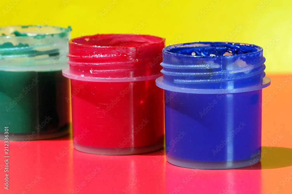 Open containers with gouache on the table Open containers with gouache on the table