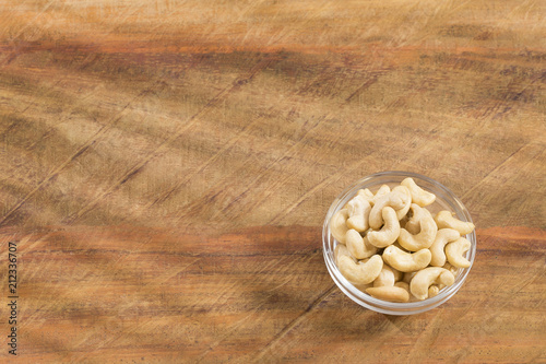 Salted cashews - Wooden background. Anacardium occidentale photo
