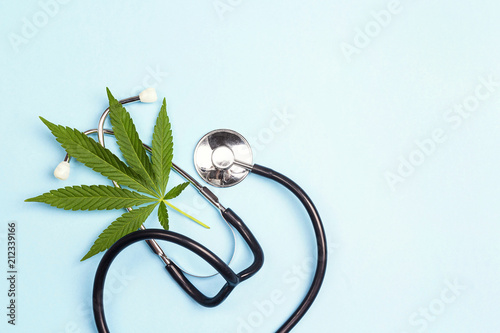 Fototapeta Naklejka Na Ścianę i Meble -  Medical cannabis and stethoscope on a blue background.