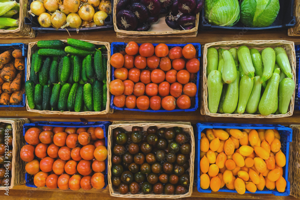 Fresh vegetables in wicker baskets on the counter of a small vegetable market. Fresh vegetables in wicker baskets on the counter of a small vegetable market.