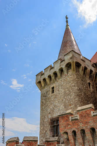 Corvin Castle, also known as Hunyadi Castle in Hunedoara, Romania.  The 400 years old magnificent Corvin Castle on a sunny day with fluffy clouds. photo