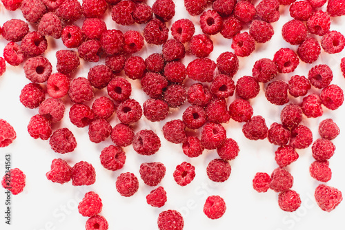 Dripping raspberry on white background. photo