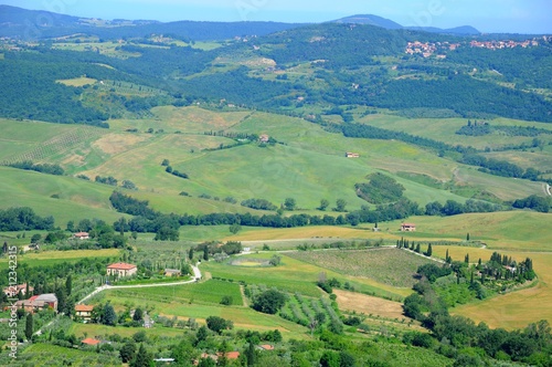 Beautiful landscape of hills, cypress trees and houses in Tuscany, Italy