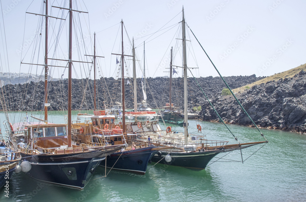 Wooden ships on port of Nea Kameni volcanic island near Santorin
