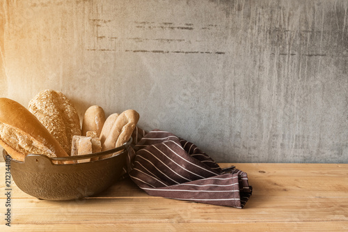 Different kinds of bread rolls on table wooden from above. Kitchen or bakery poster design