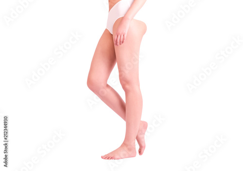 Side view of a beautiful naked legs of a woman walking isolated on a white background