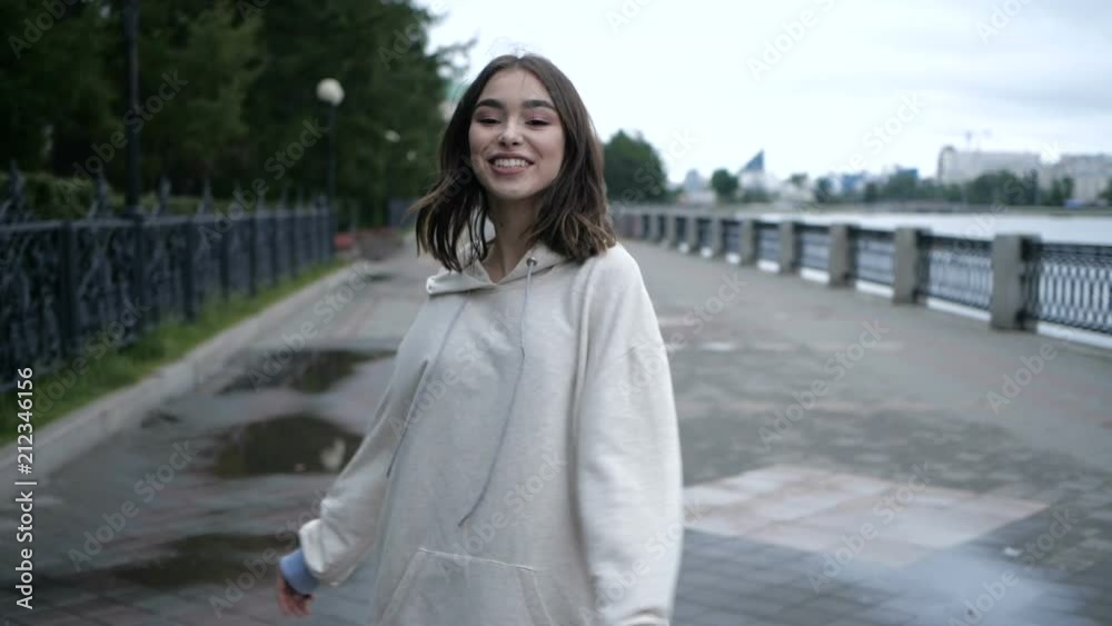 Brunette is taking a walk along the river side Brunette is taking a walk along the river side