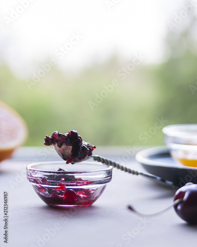 The concept of summer style. Fresh homemade delicious orange and cherry jam. Lifestyle. Selective focus.