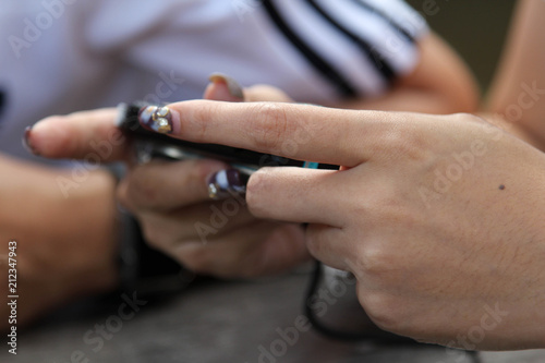 Female hand playing on a portable game device.