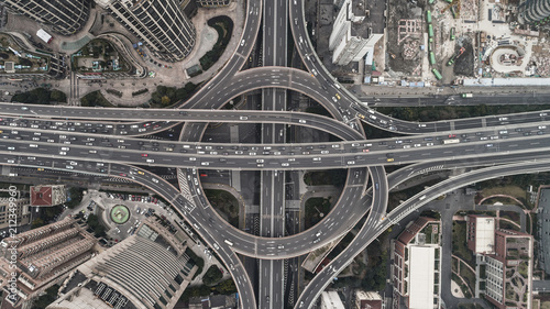 Photography Aerial view of highway and overpass in city on a cloudy day