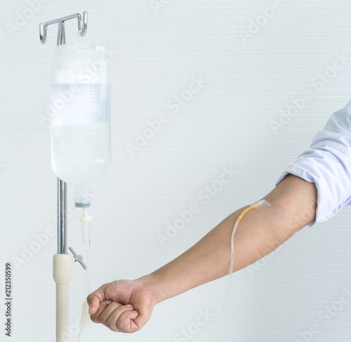 Asian male showing and demonstrate how to infusion drip in doctor class by infusion drip himself on his hand.