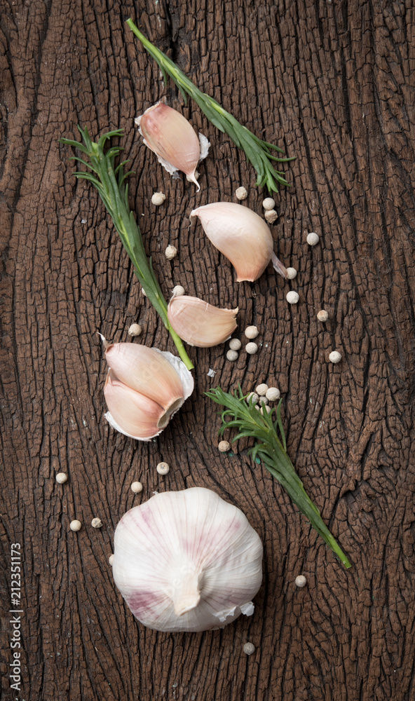Garlic,rosemary and pepper on wooden,top view Garlic,rosemary and pepper on wooden,top view