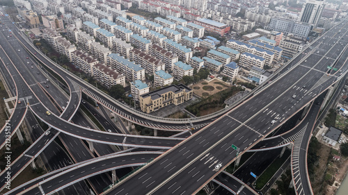 Aerial view of highway and overpass in city on a cloudy day © Bob