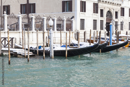 Snow-covered gondolas in the Grand Canal, San Polo, Venice, Italy during winter and the Siberian weather front 