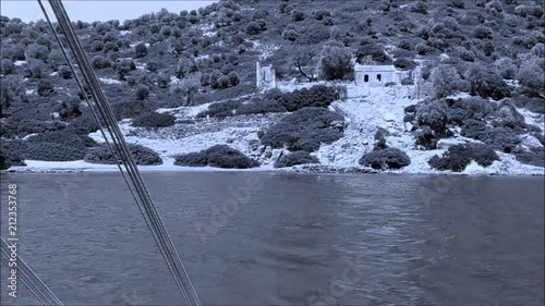 Kameriye Adasi, Turkey, View From Boat, Tourists arrive on pleasure yachts to see the sights of the island. Panorama of nature of the Aegean Sea on the island, blue-toned photo