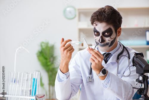 Scary monster doctor working in lab photo