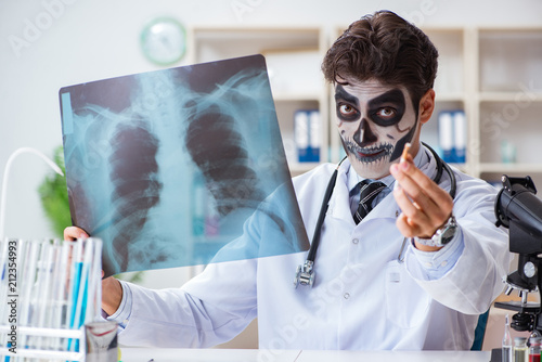 Scary monster doctor working in lab photo