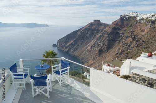 Whitewashed Houses on Cliffs with Sea View, Table and Chairs in Fira, Santorini, Cyclades, Greece