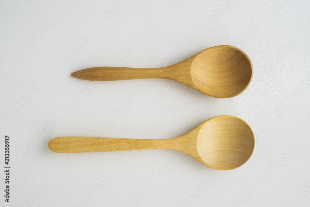 Close-up wooden spoon isolated yellow background Close-up wooden spoon isolated yellow background
