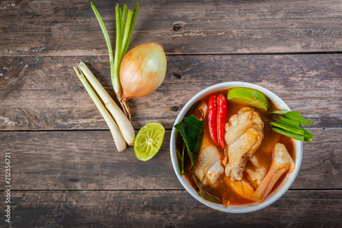 Photos Chicken tom yam  in a hot white bowl to eat.