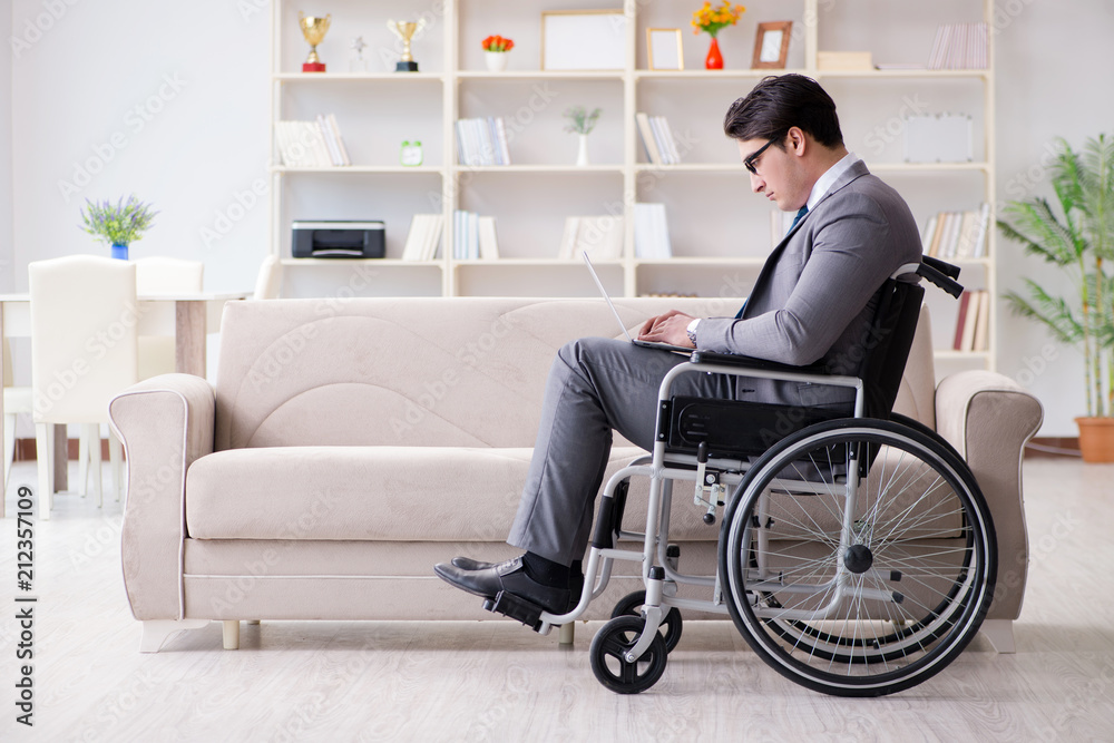 Dsabled businessman on wheelchair working home Dsabled businessman on wheelchair working home