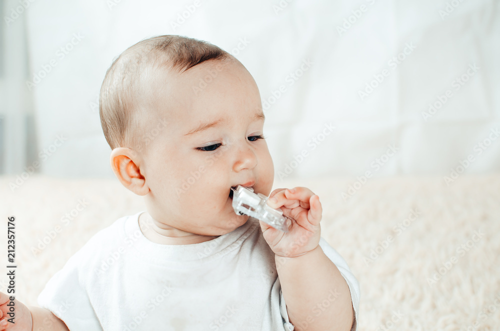 An infant plays with the pills on the bed An infant plays with the pills on the bed