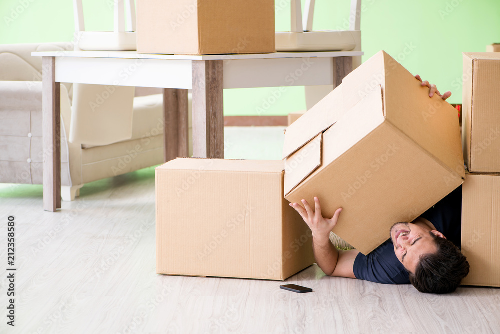 Fototapeta premium Man moving house with boxes