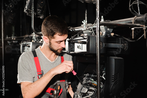 The lighting engineer adjusts the lights on the stage. © nagaets