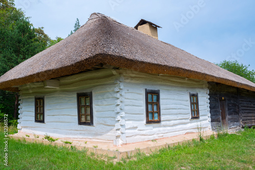 Old wooden house, with a thatched roof, outside the city of Kiev, Ukraine