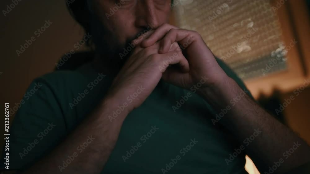 Man waiting for e-mail reply and drinking coffee in dark interior, low key footage Man waiting for e-mail reply and drinking coffee in dark interior, low key footage