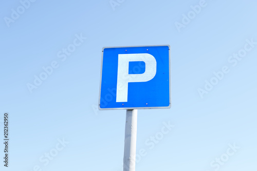 Parking P sign blue white square against sky background