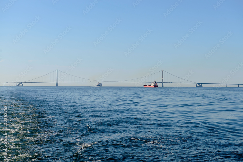 Ship sailing under Great Belt Bridge