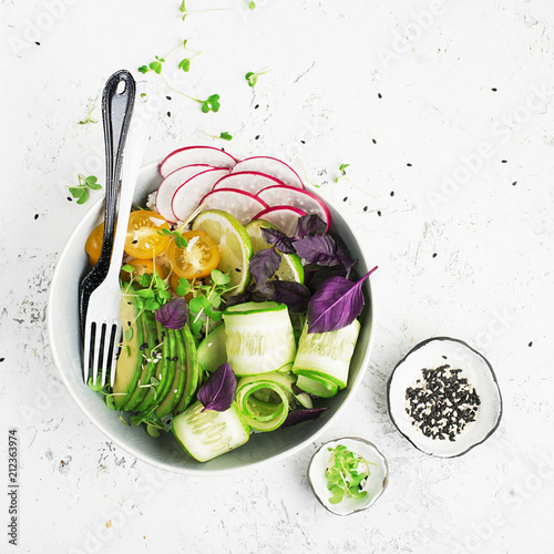 Vegetarian dinner buddha bowl. Vegetables, rice, micro greens, avocado bowl with chickpeas. Top View. photo