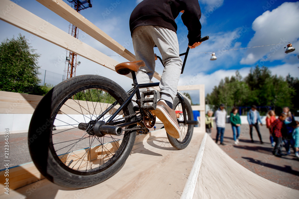 Guy is riding bmx bike, is preparing to jump on trampoline, ramp. Concept  extreme teenagers. Stock Photo | Adobe Stock