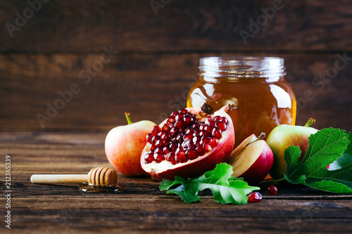 Jewish holiday Rosh Hashanah, Apples Honey and Pomegranate on the Wooden Table, Copy space photo