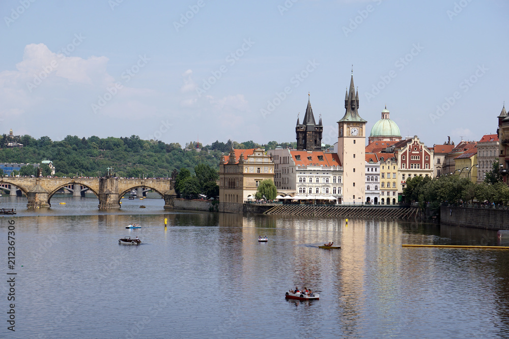 View of Charles Bridge, Old Town Water Tower reflected in the Vltava river with pedal boats, Prague, Czech Republic View of Charles Bridge, Old Town Water Tower reflected in the Vltava river with pedal boats, Prague, Czech Republic
