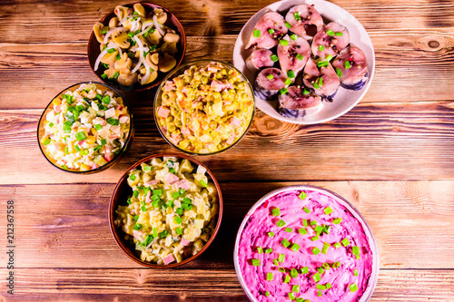 Different festive dishes on a wooden table. Top view