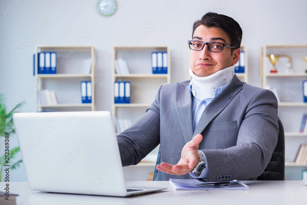 Businessman with neck injury working in the office Businessman with neck injury working in the office