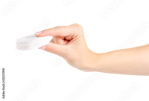 Wadded cotton pads in a hand on a white background isolation
