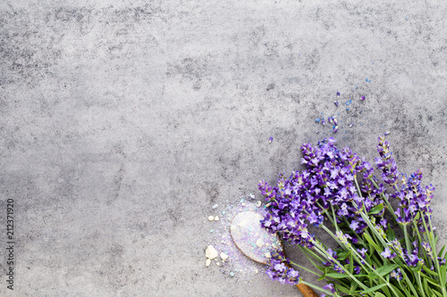 Fototapeta Naklejka Na Ścianę i Meble -  Essential lavender salt with flowers top view.