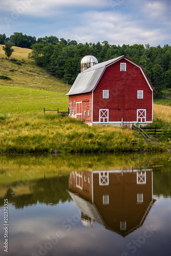 Red barn reflected in pond