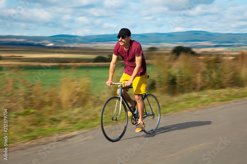 Natural view with cyclist going somewhere with stylish bike