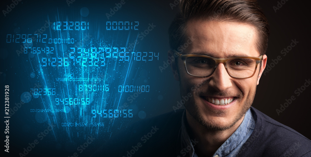 Portrait of a young businessman with blue numbers next to him on a dark background Portrait of a young businessman with blue numbers next to him on a dark background