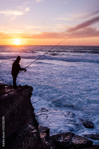 Silhouette of a fisherman to fish in the ocean, Portugal