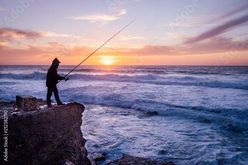 Silhouette of a fisherman to fish in the ocean, Portugal