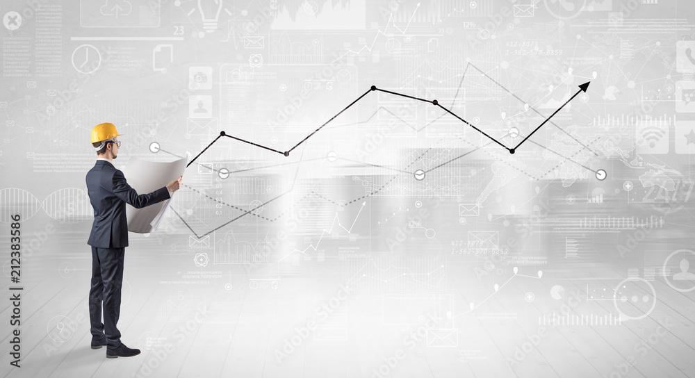 Engineer with construction helmet holding a plan and standing with graphs, charts and reports on the background Engineer with construction helmet holding a plan and standing with graphs, charts and reports on the background