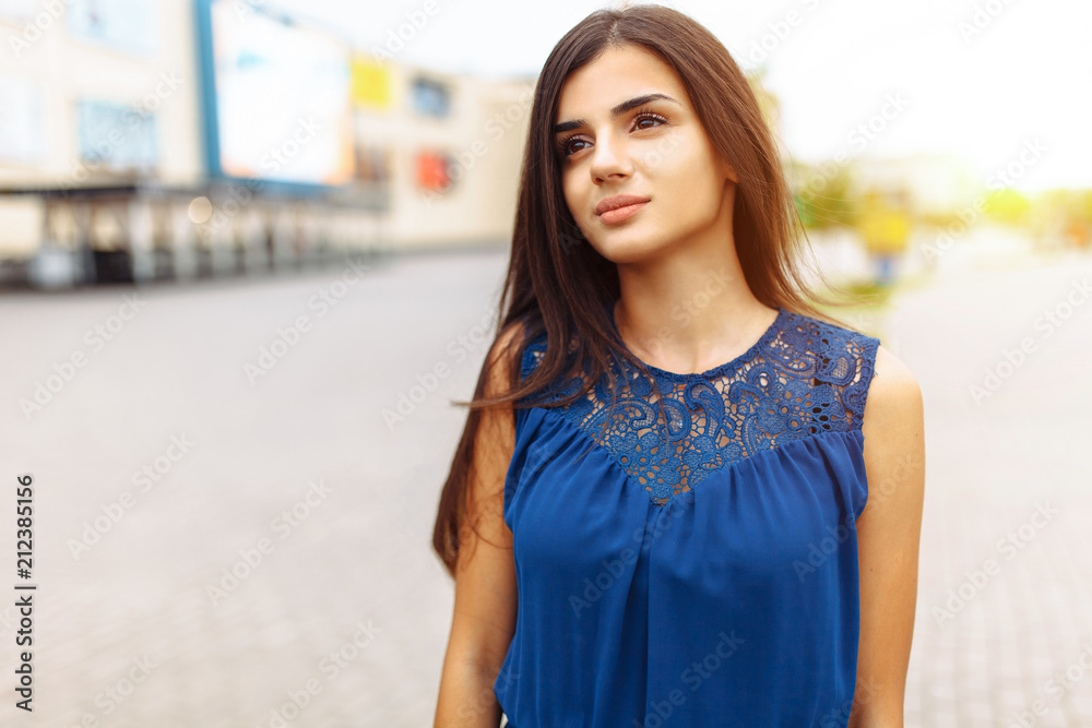 portrait of a girl on the street, a beautiful woman in a blue dress, close-up