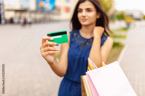 girl with shopping and card on the street, payment card, close-up