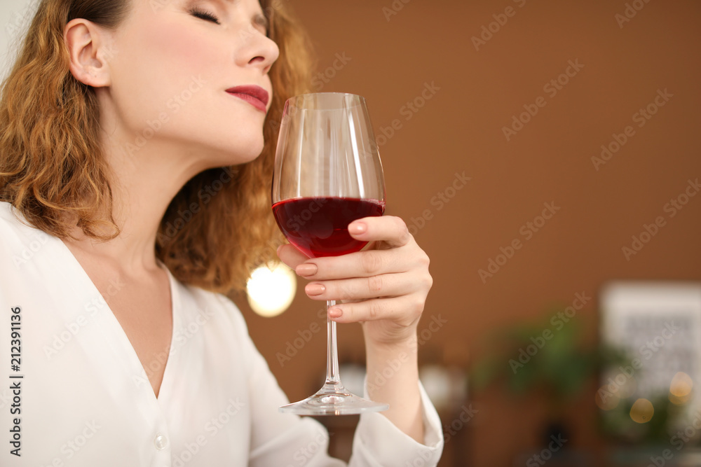 Woman with glass of delicious wine indoors Woman with glass of delicious wine indoors