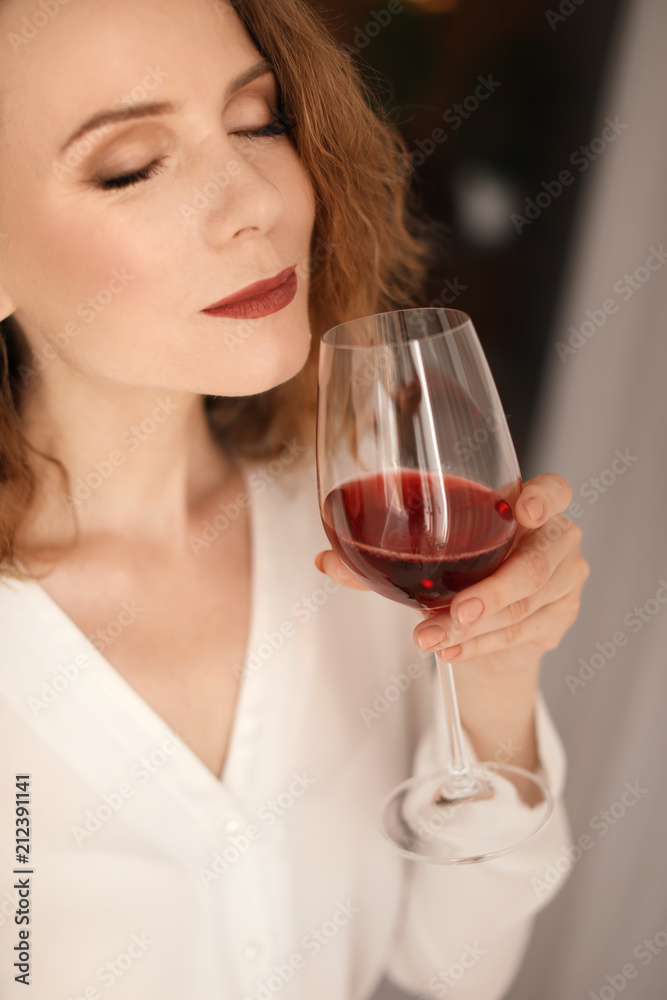 Woman with glass of delicious wine indoors Woman with glass of delicious wine indoors